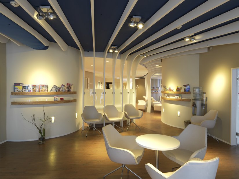 The light chairs in the waiting area create a direct contrast to the walnut colored PVC floor.