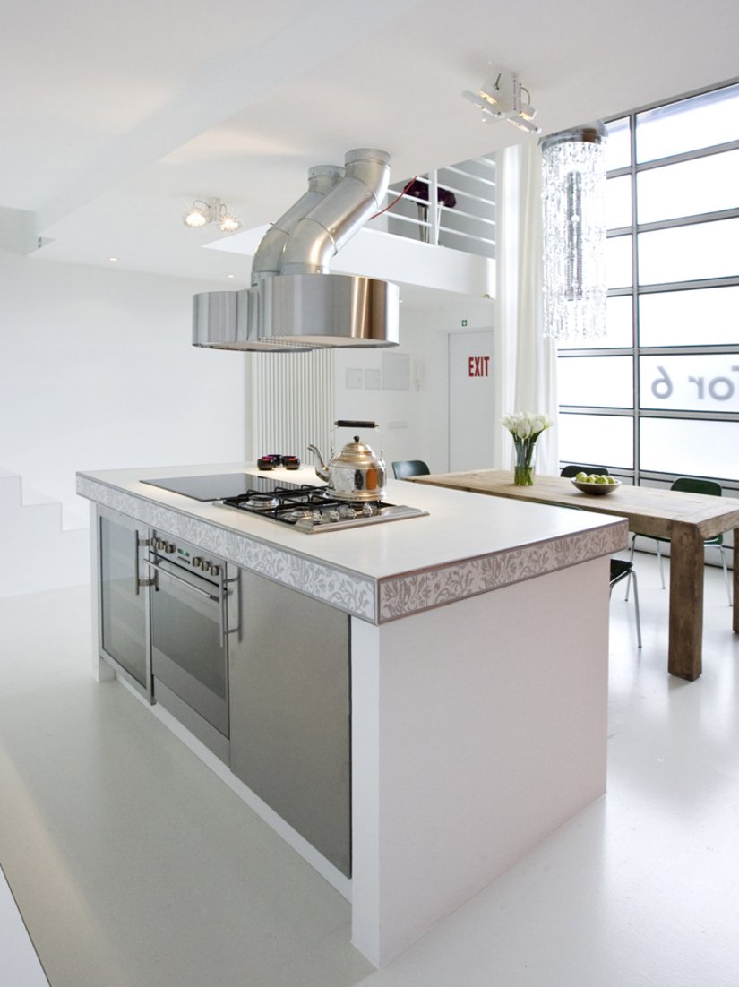 The white, high-quality kitchenette fitted down to the smallest detail, is integrated subtly here.