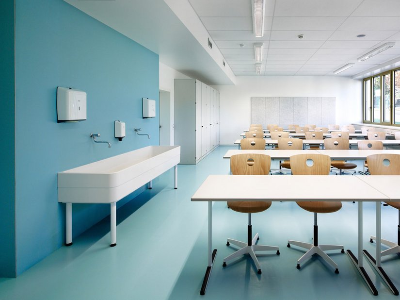 <p>The colors light blue, turquoise, green and yellow green are present, used in the rubber flooring in the classrooms and administrative spaces.</p>