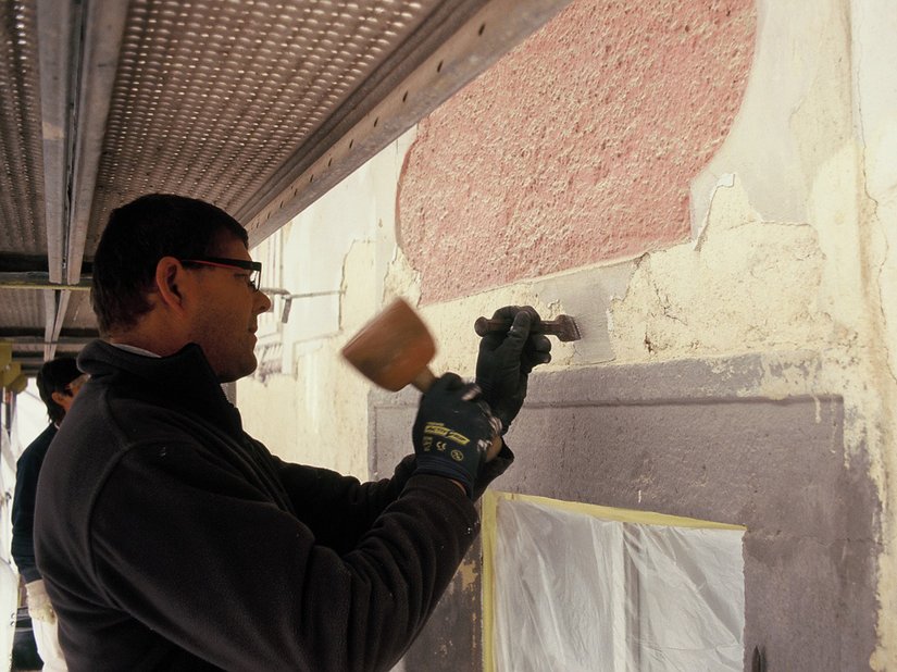 With meticulous attention to detail, render and paint were removed before the coating was re-applied.