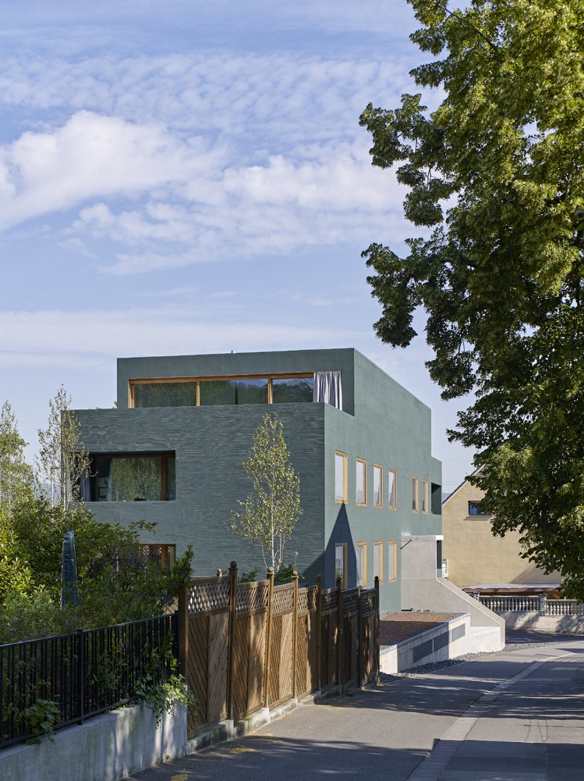 A modern monolith surrounded by 1960s houses as a result of densification in the area.