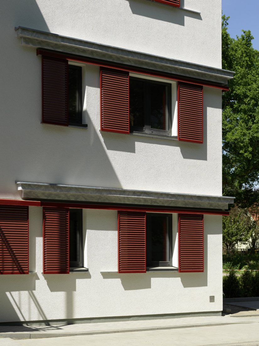 The brown red sliding panels and their running rails create a powerful color accent.