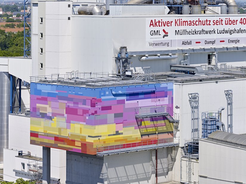 The simple gray facade makes the colored elements of the building stand out.