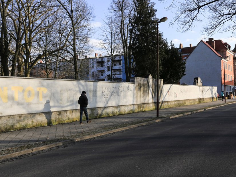 Past: A glimpse at the wall, in need of renovation, that surrounds the city park.