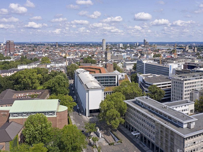 In a prominent location in Cologne’s banking district, the building opens towards the marketplace with an exposed concrete facade of urban significance.