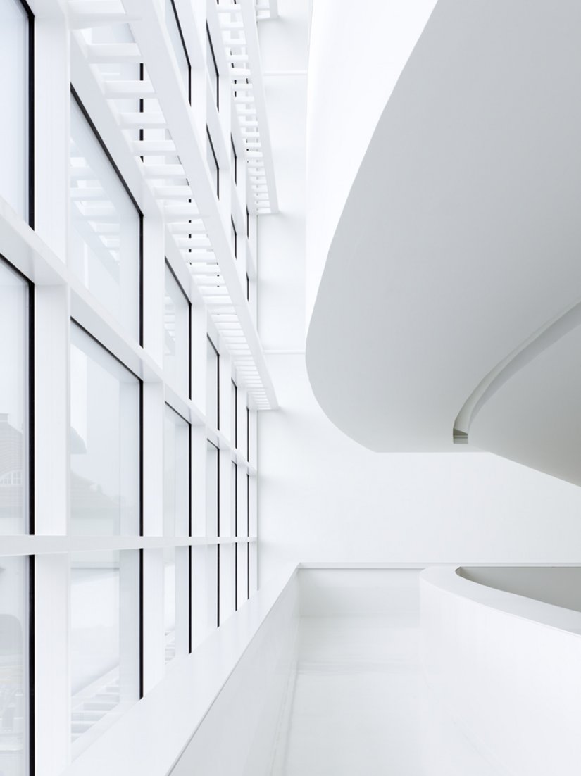 A view between the glass facade and spiral staircase.