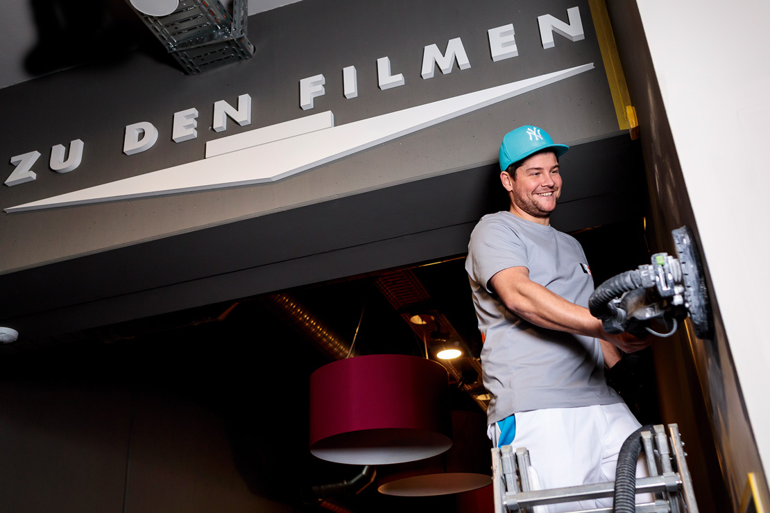 Tradesman Daniel is working on a wall in the old cinema foyer